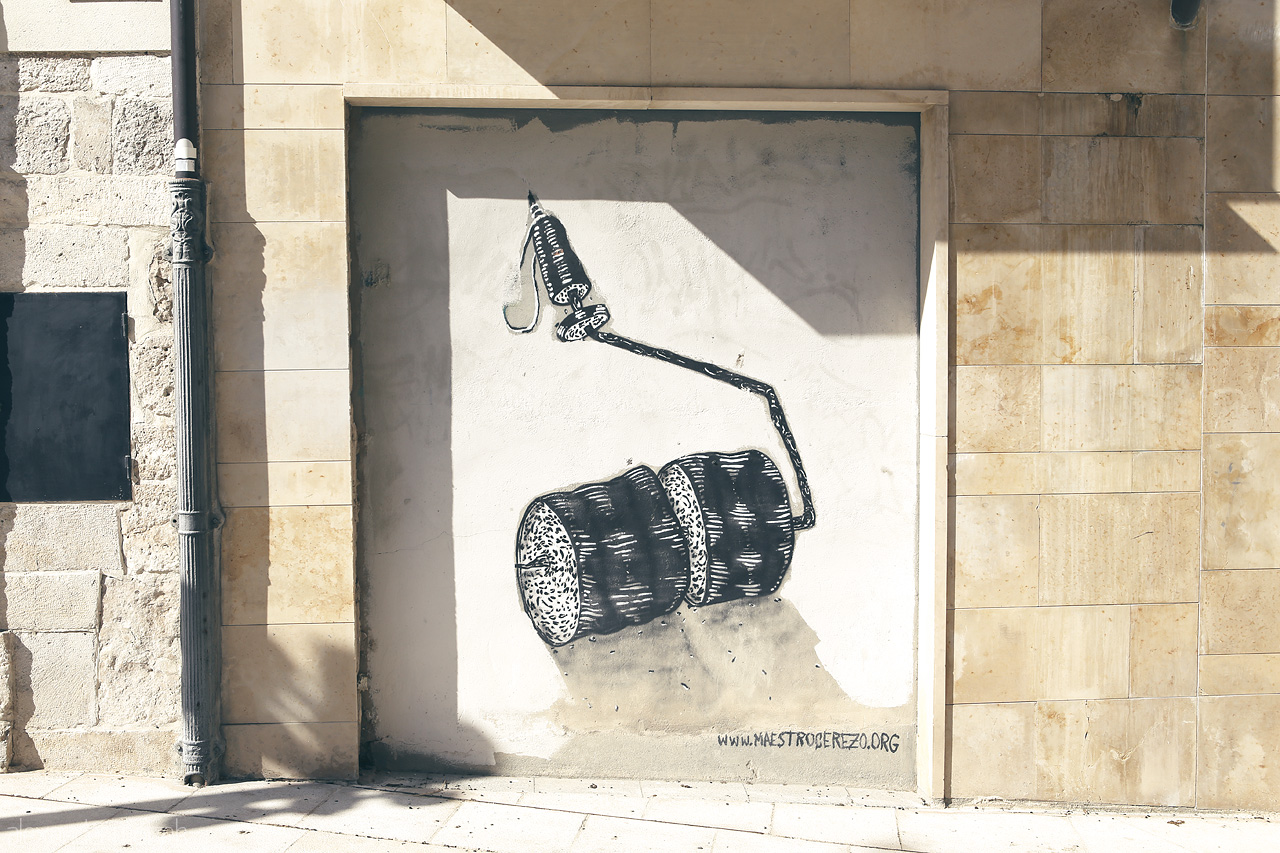 Foto von Street art graffiti of a dangling microphone in Burgos, capturing the urban scene's vibrant culture.