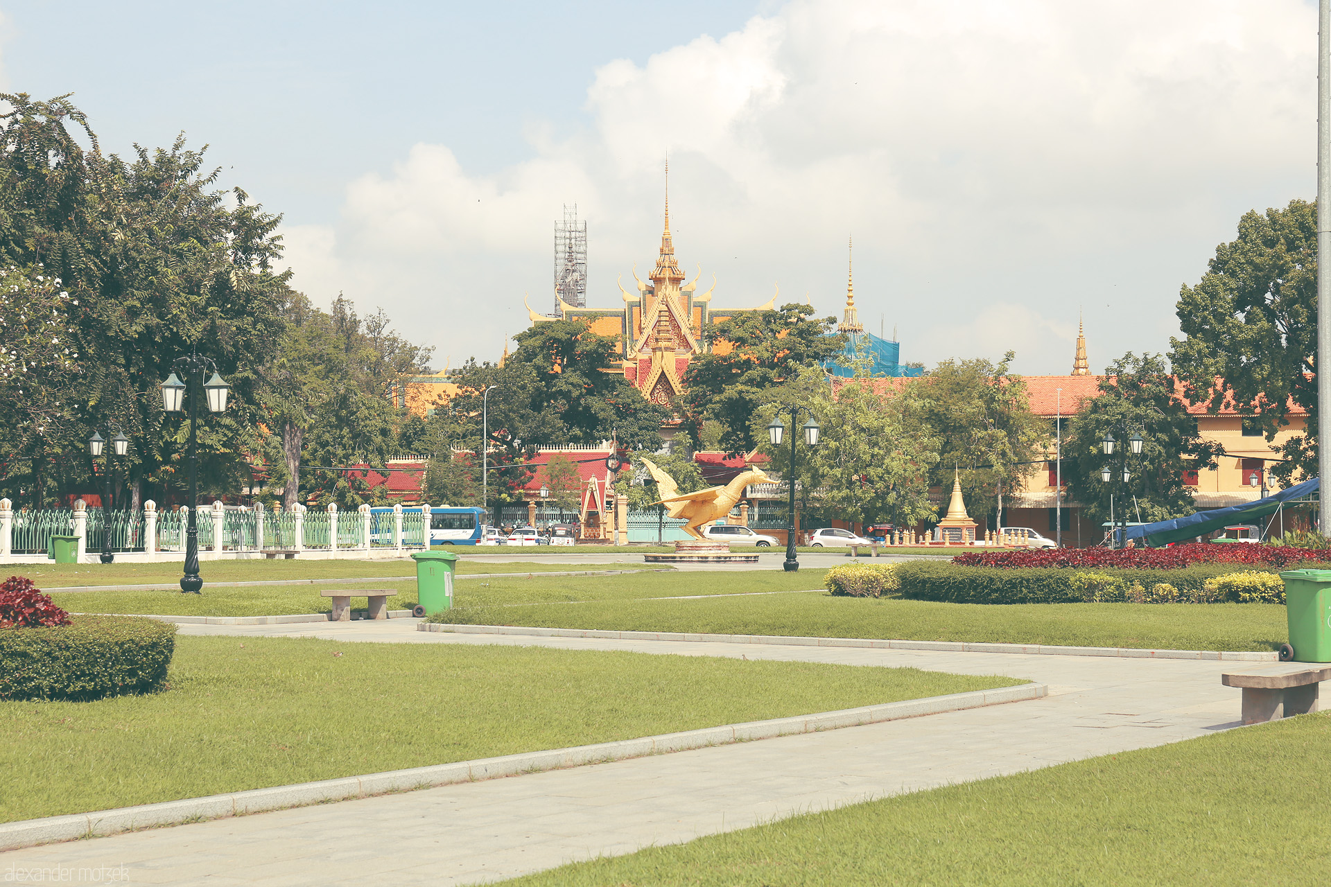 Sovann Phnom Foto von Golden hsieng bird statue and lush gardens frame ornate Wat Botum in Phnom Penh, Cambodia, beneath tropical skies.