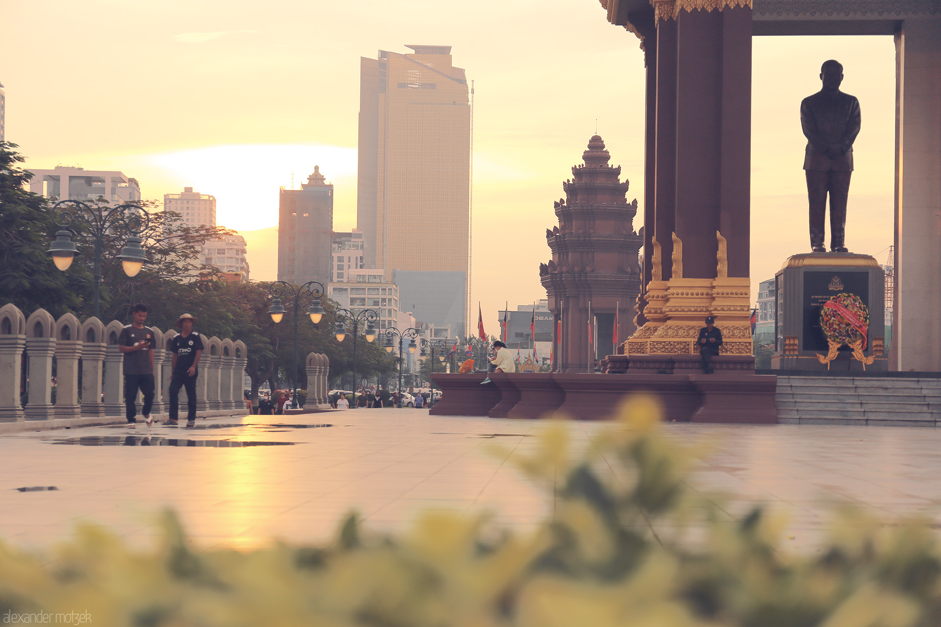 Chaktomuk Dusk Foto von Sunset light bathes Phnom Penh’s skyline and Independence Monument, blending past and present in a golden Cambodian evening.