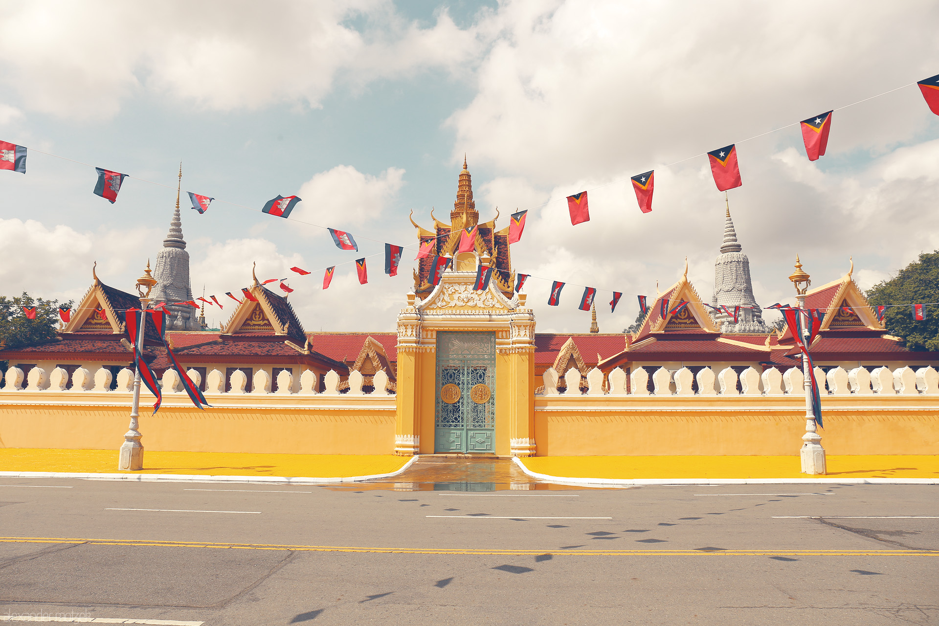 Royal Threads Foto von Vivid yellow gates and fluttering Khmer flags guard the ornate Royal Palace under Phnom Penh’s sunlit skies.