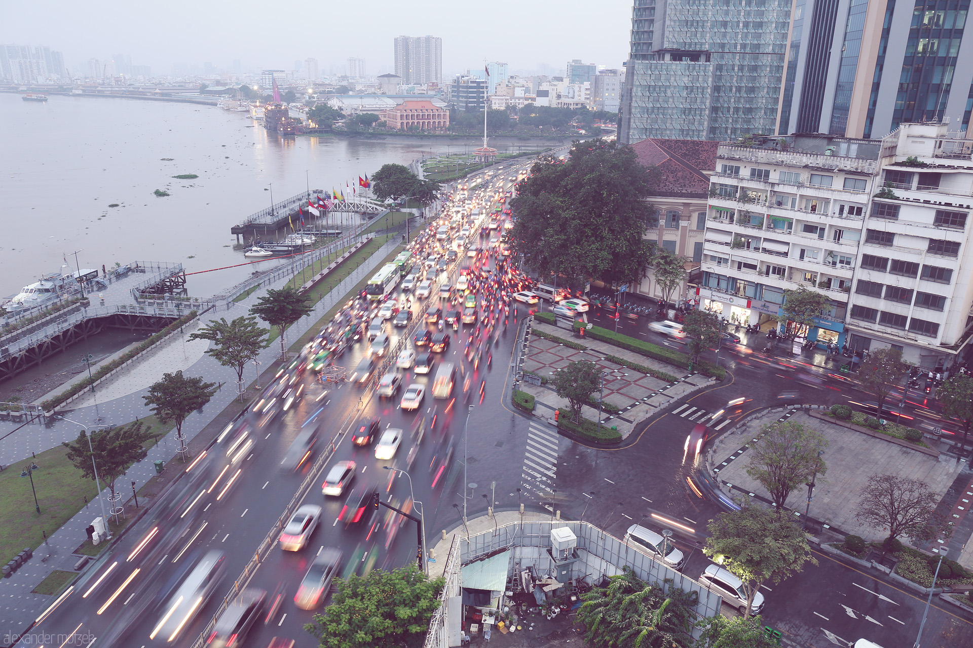 Pulse of Sài Gòn Foto von Blurred traffic pulses beside the Saigon River at Ben Bach Dang, capturing Ho Chi Minh City's vibrant twilight motion.