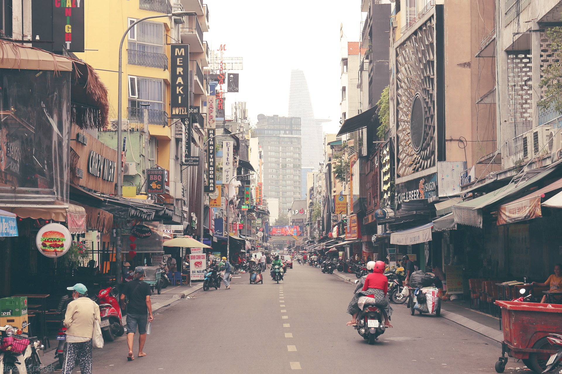 Saigon Sáng Mo Foto von Morning scooters weave through Bùi Vien street, Saigon’s pulse beating beneath the Bitexco Tower skyline. Ho Chi Minh City, Vietnam.